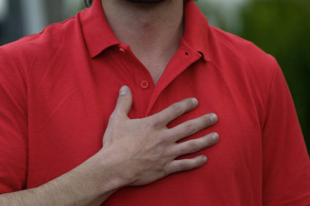 istock Man in red t-shirt with hand on chest 1436510071