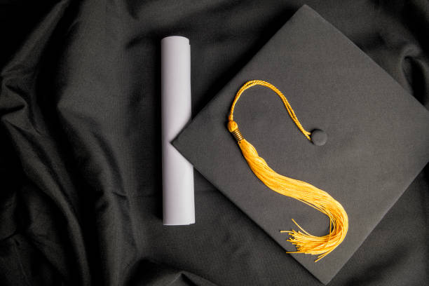 istock Tassel Diploma and Cap and Gown 1436512068