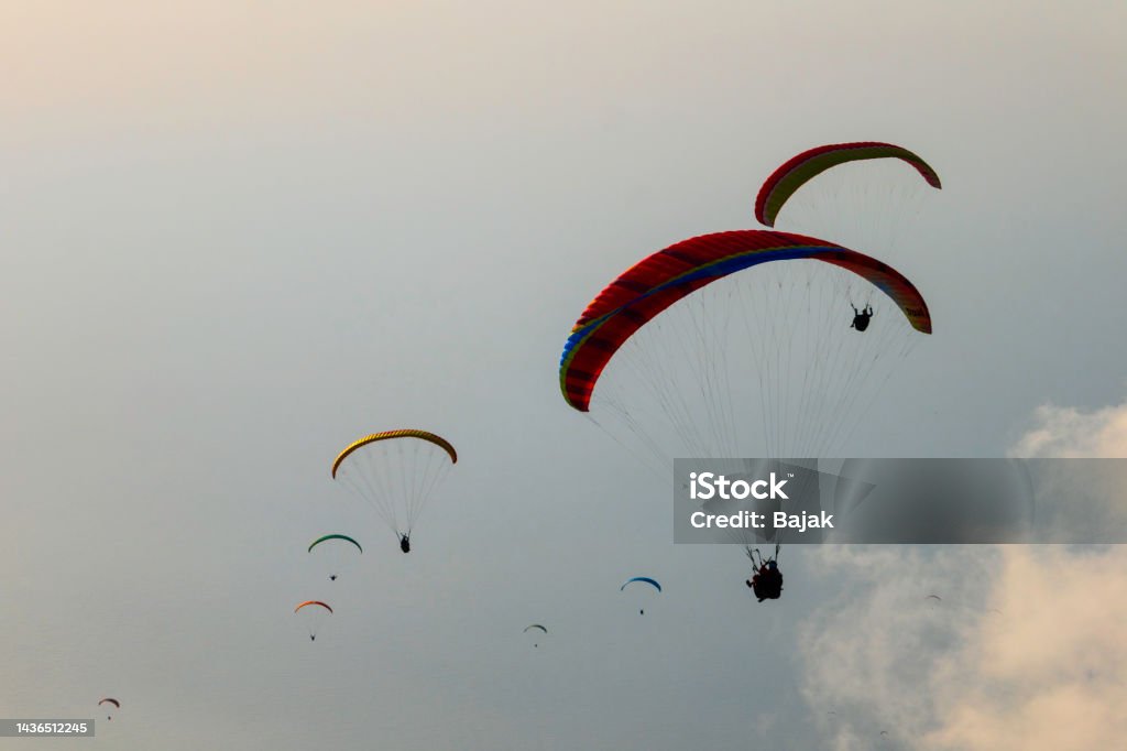 Paragliders at sunset Many paraglider at sunset over the sea among the clouds Abstract Stock Photo