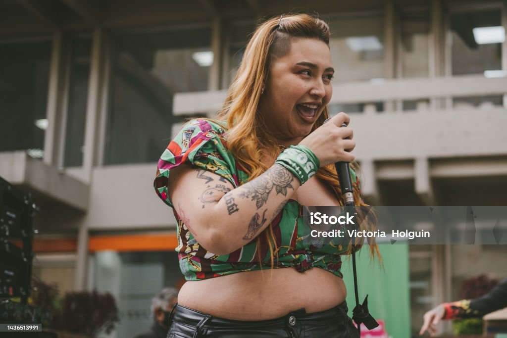 Woman singing Woman singing in front of an audience Rap Stock Photo