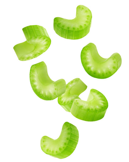 Falling celery slice isolated on white background, clipping path, full depth of field stock photo