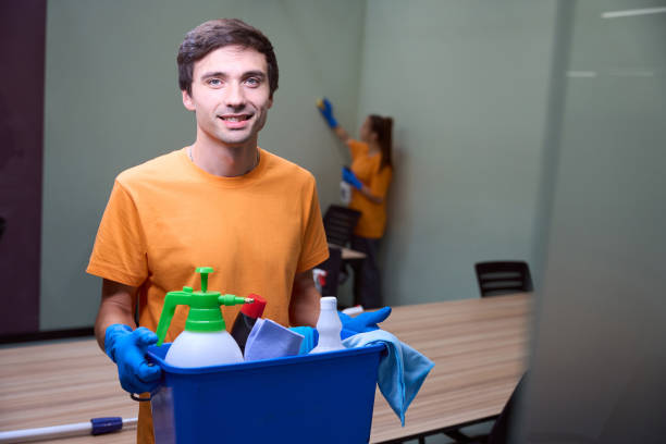 istock Professional cleaner demonstrating a box of different housecleaning items 1436521716