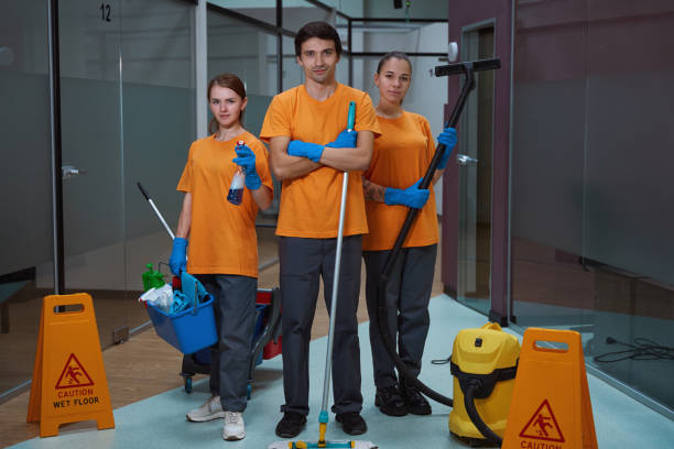 istock Efficient cleaners standing together with professional equipment in hands 1436521849