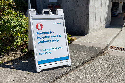 Vancouver, Canada - July 12, 2022: View of sign Parking for hospital staff and patients only in front of Lions Gate Hospital