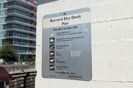 Vancouver, Canada - July 12,2022: View of information sign Burrard Dry Dock Pier in North Vancouver