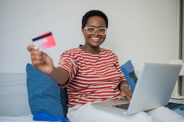 istock Cheerful  woman doing online shopping 1436524050