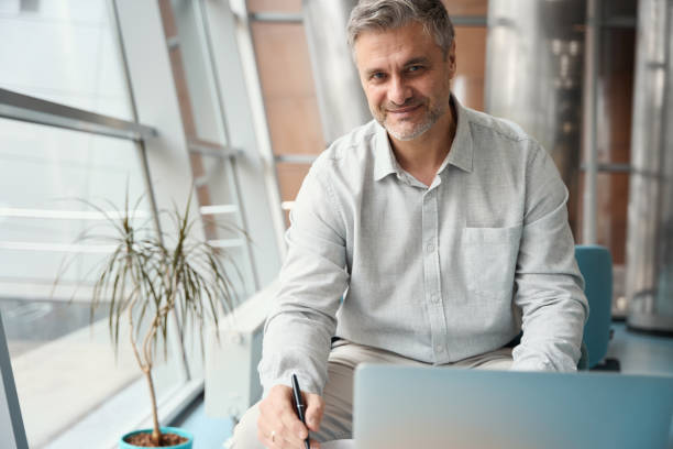 istock Boss signs work papers in a coworking space among plants 1436525152