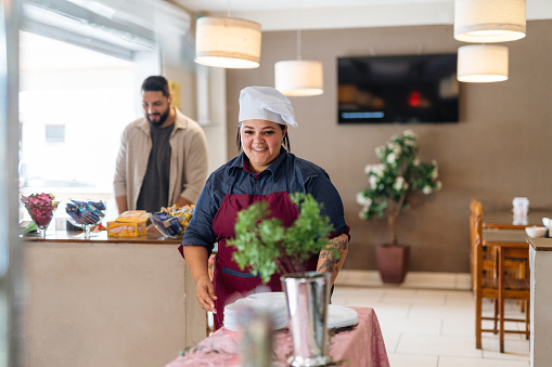 Female chef in restaurant hall