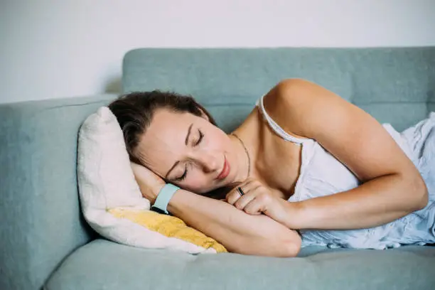 Woman Sleeping Comfortably In Living Room