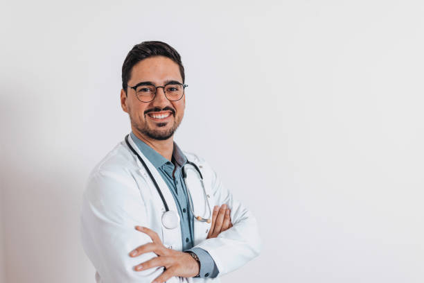 istock Smiling handsome doctor on white background 1436528387