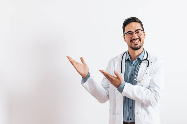 Cheerful doctor pointing at copy space stock photo