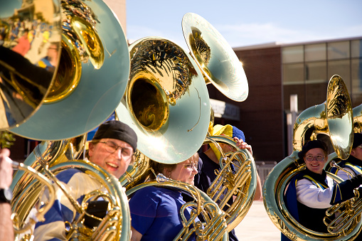 Newark, Delaware, USA - October 22, 2022: Marching Band tuba section performing at a Delaware University Blue Hens Football Game.