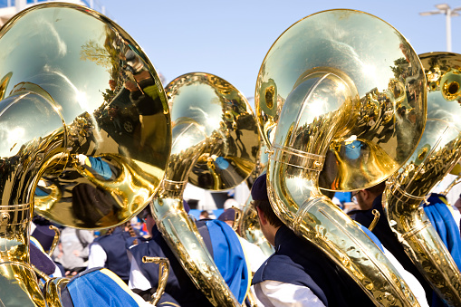 Newark, Delaware, USA - October 22, 2022: Marching Band tuba section performing at a Delaware University Blue Hens Football Game.