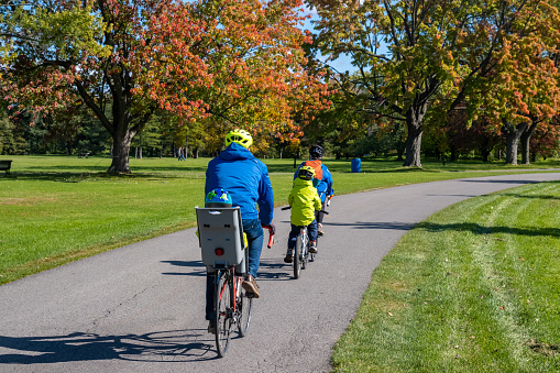 Montreal, Canada - 10 October 2022: People riding bikes in Maisonneuve Park in the Autumn season