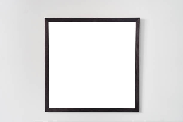istock An empty square photo frame with a black border hanging on a white wall 1436535208