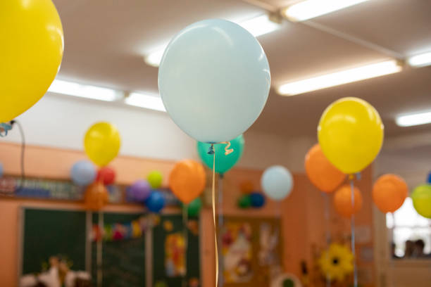 Hot air balloons in school. Holiday in school classroom. Details of holiday. Hot air balloons in school. Holiday in school classroom. Details of holiday. Inflatable balls on rope. helium stock pictures, royalty-free photos & images
