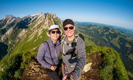 Alpstein selfie of Senior couple hiking at Altenalp Türm, Switzerland.