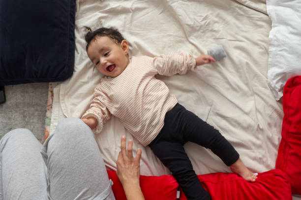 istock Baby girl playing with her mother 1436543682