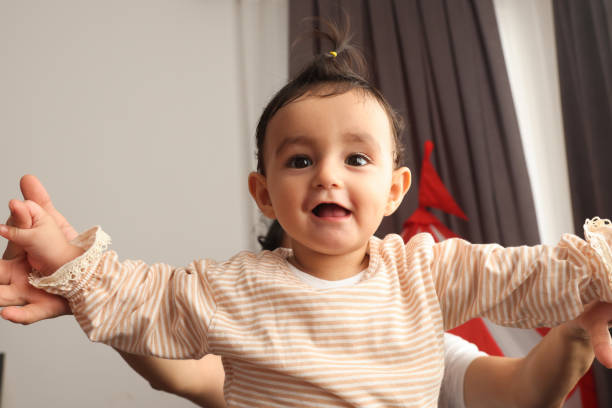 istock Baby girl playing with her mother 1436543779