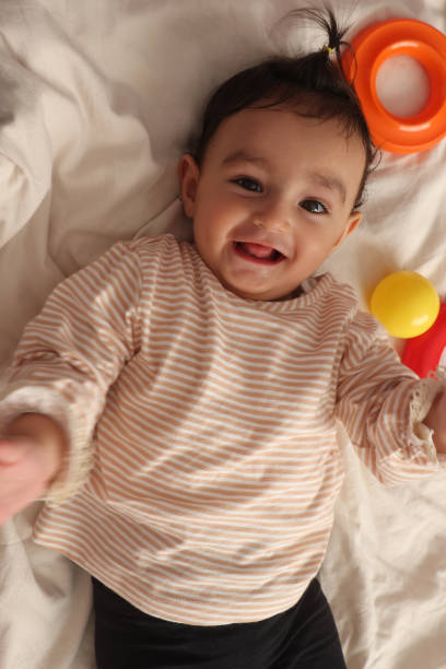 istock Cute baby boy lying in bed 1436543800