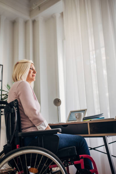 istock Disabled woman in home office 1436549740