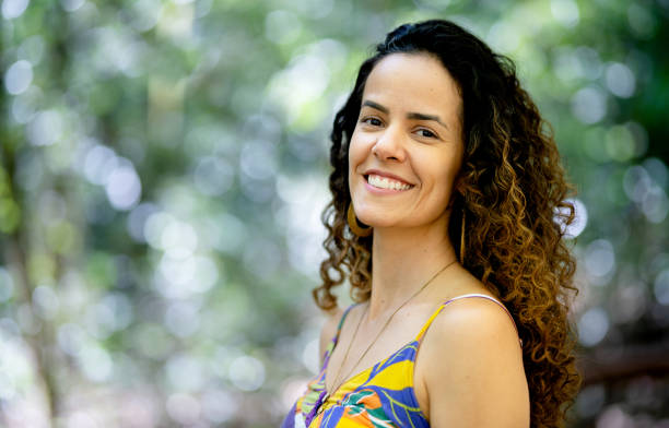 istock Smiling young woman standing alone outside in a forest 1436558300