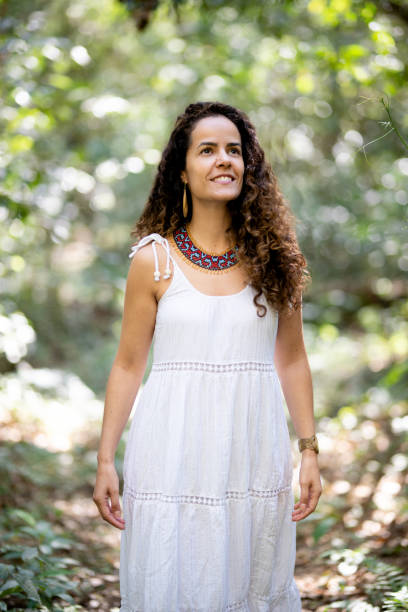 istock Smiling young woman standing outside on a forest path 1436558316