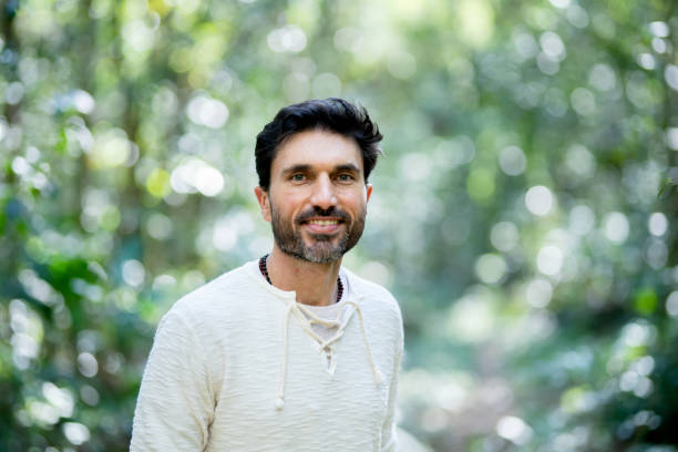 istock Man smiling during a walk outdoors in a forest 1436558318
