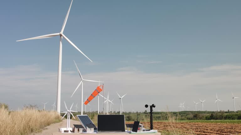 Laptop and equipment at field of wind turbine farm