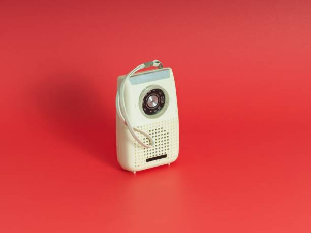 istock A vintage old transistor AM radio centered on a red background 1436559653