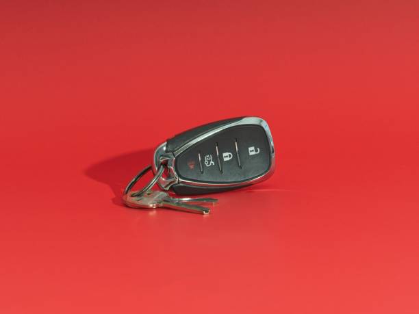 istock Car remote release key fob with analog keys centered on a red background 1436559676