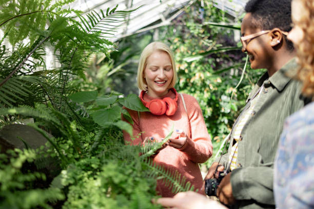 istock Youth womans cheerfully smiling while leisure exploring greenhouse 1436563877