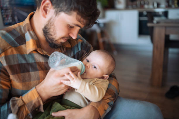 istock Father Feeding baby with baby bottle. 1436564165