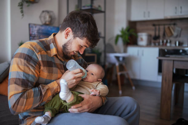 istock Father Feeding baby with baby bottle. 1436564174