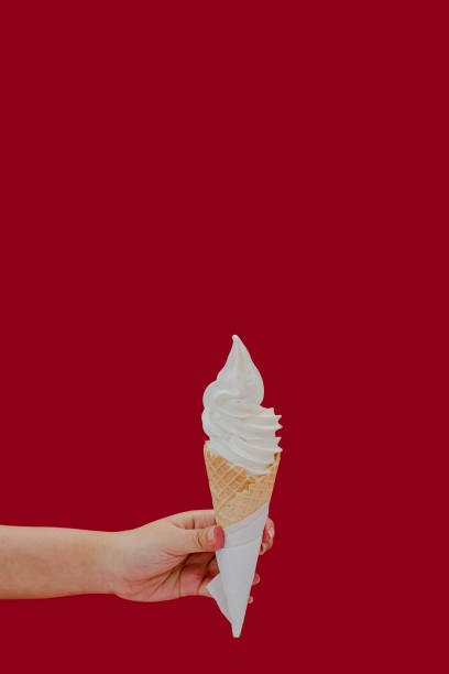 istock Vanilla ice cream cone hold by hand 1436566270