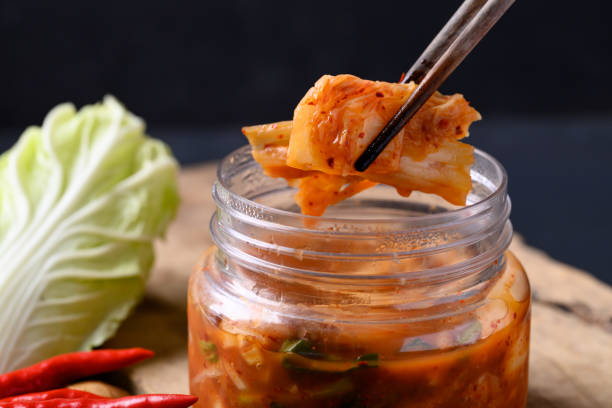 istock Kimchi cabbage in bowl eating by chopsticks 1436566536