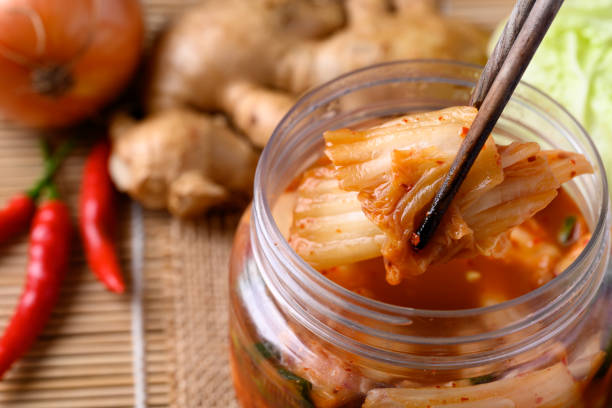 istock Kimchi cabbage in bowl eating by chopsticks 1436566582