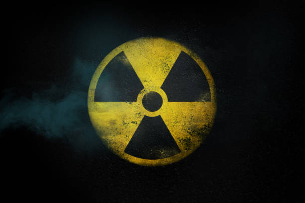 istock Nuclear energy radioactive round yellow symbol on asphalt texture 1436566821