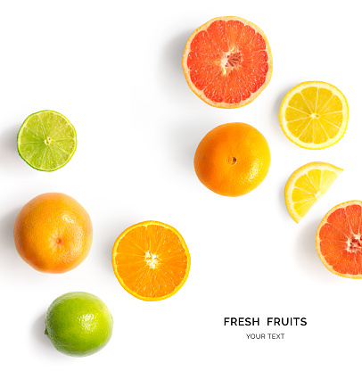 Creative layout made of lemon, lime, orange and grapefruit. Flat lay. Food concept. Lemon, lime, orange and grapefruit on white background.