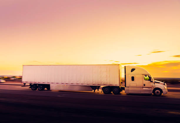 istock White semi-truck driving on the highway - panning motion blur 1436574270
