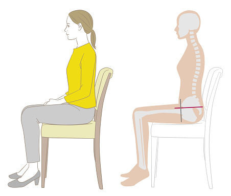 A woman and a skeleton figure sitting on a chair with the correct posture