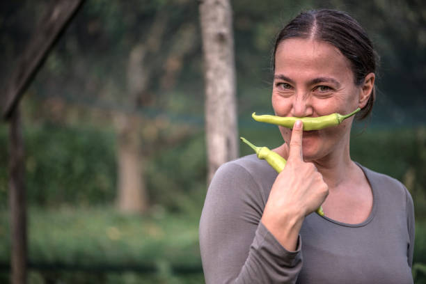 Woman Enjoy Harvesting Fresh Vegetables from her Own Grown Vegetable Garden stock photo