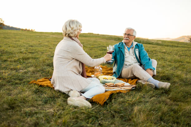 istock Senior couple enjoyig a wine 1436578900