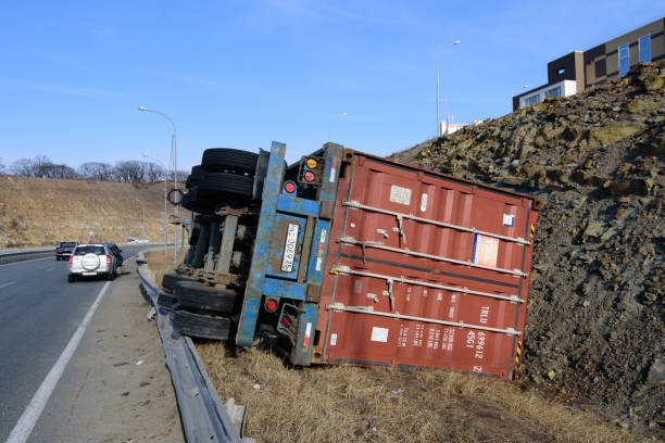 Road accident, the overturned trailer with a container. stock photo