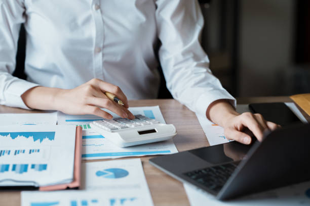 istock Banner woman work office desk finance chart graph on table. Panoramic entrepreneur financial audit woman hands working paperwork office. Banner Businesswoman Audit financial concept with copy space 1436584225