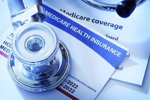 A stethoscope rests on top of a Medicare insurance card