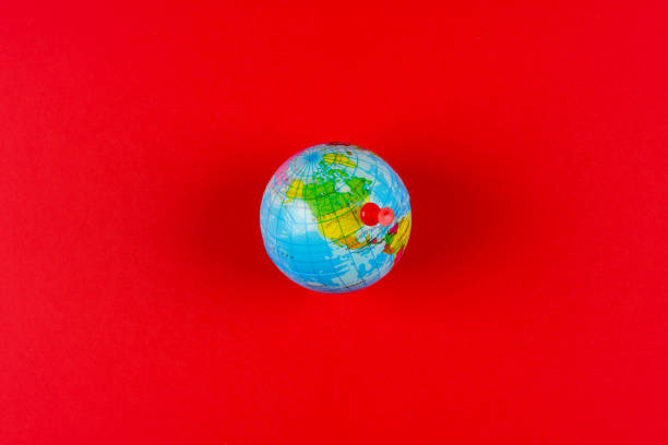 French flag pointing France in cheap plastic globe. Shallow depth of field