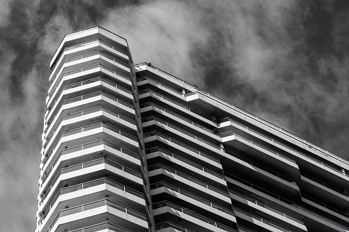 Detail of a tall city building with overcast sky.