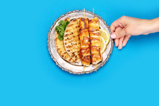 Chicken skewers souvlaki on color background.