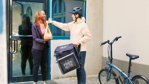 istock Food delivery courier delivering restaurant meal in package 1436600684